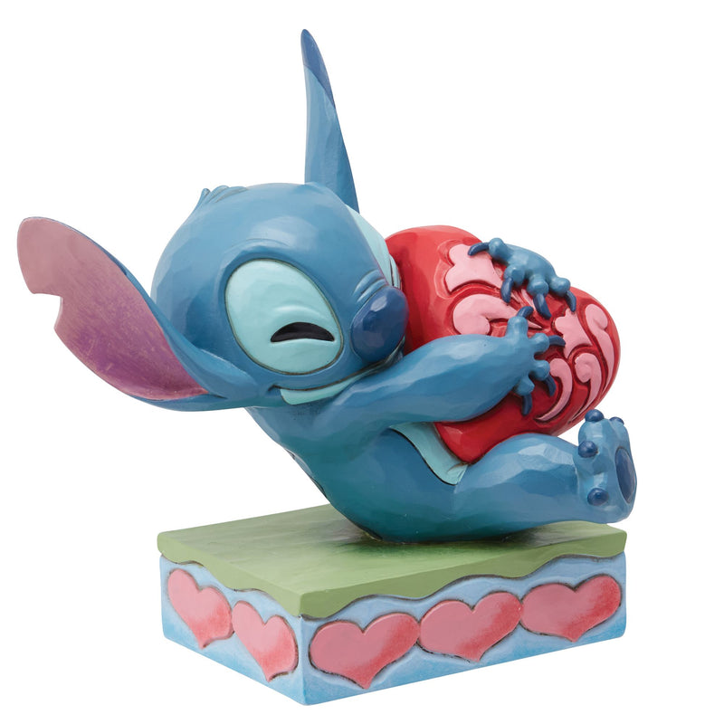Figurine Stitch câlinant un coeur - Disney Traditions